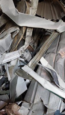 A pile of scrap metal is sitting on top of each other.