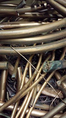 A pile of brass wires sitting on top of each other on a table.