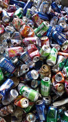 A pile of crushed aluminum cans sitting on top of each other.