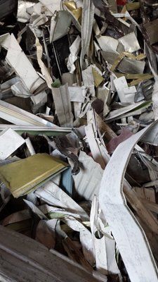 A pile of scrap metal is sitting on top of a wooden table.