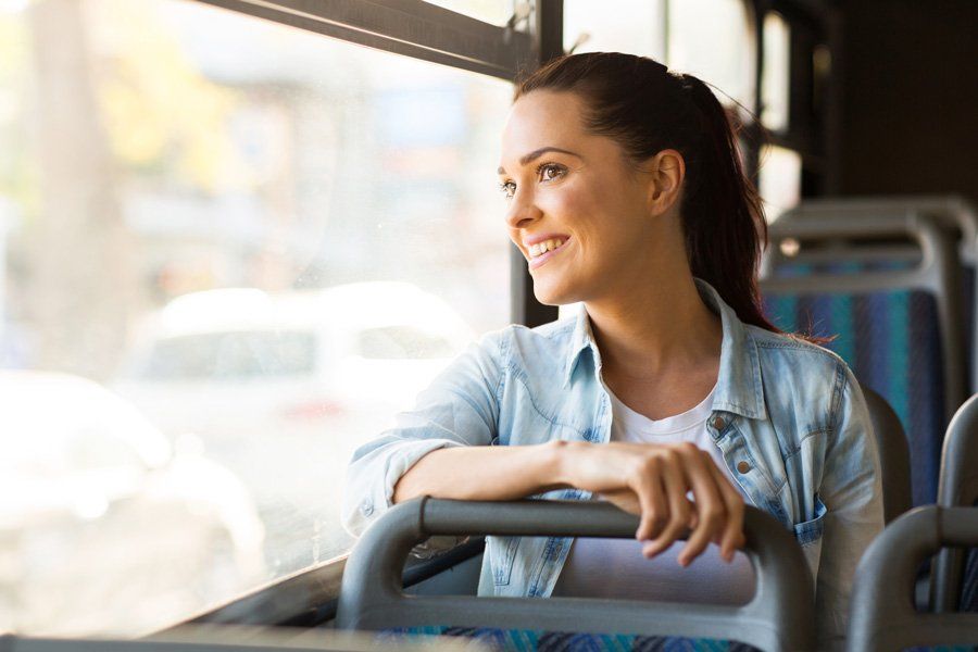 Happy Woman Passengers In A Travel Bus — Greenville, SC — Jeans Bus Service Inc