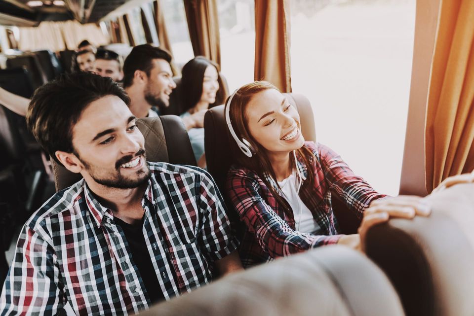 Young Smiling Couple Traveling — Greenville, SC — Jean's Bus Service, Inc. Young Smiling Couple Traveling — Greenville, SC — Jean's Bus Service, Inc.