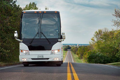 Charter Bus On Asphalt Highway