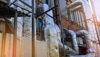 Wall of industrial building with pipes - Mechanical insulation in North Charleston, SC