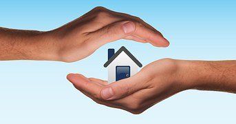 hands holding a house