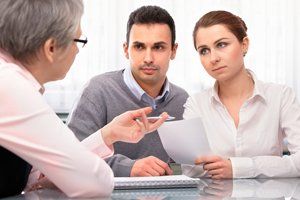 couple having conversation with landlord