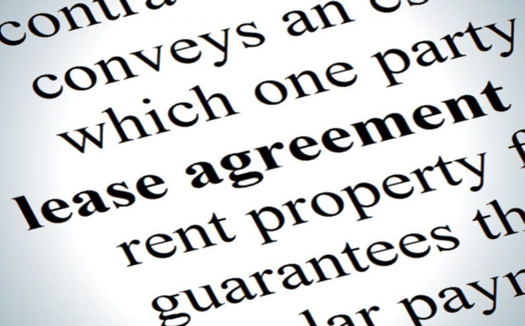 Close-up of document with 'lease agreement,' indicating a rental property contract.