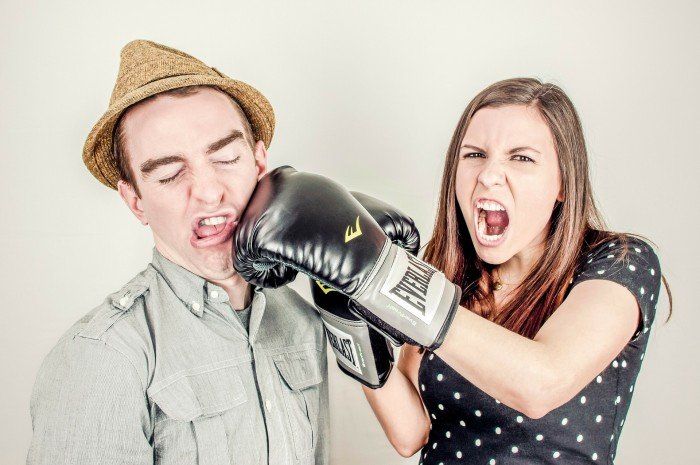 man getting punched by woman