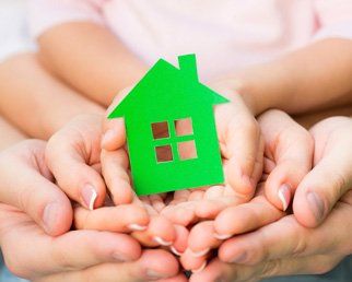 Family holding house icon