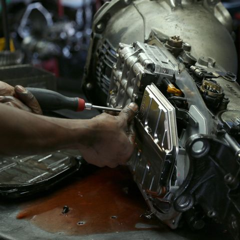 Mechanic Working On Car Transmission — Chicago, IL – AC Transmission Mechanic Working On Car Transmission — Chicago, IL – AC Transmission