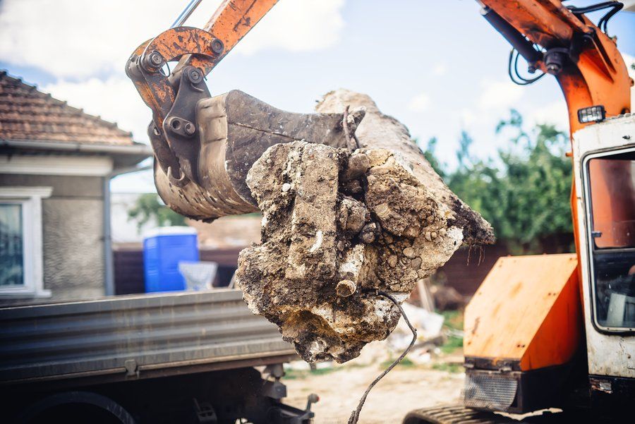 a backhoe truck clearing the site