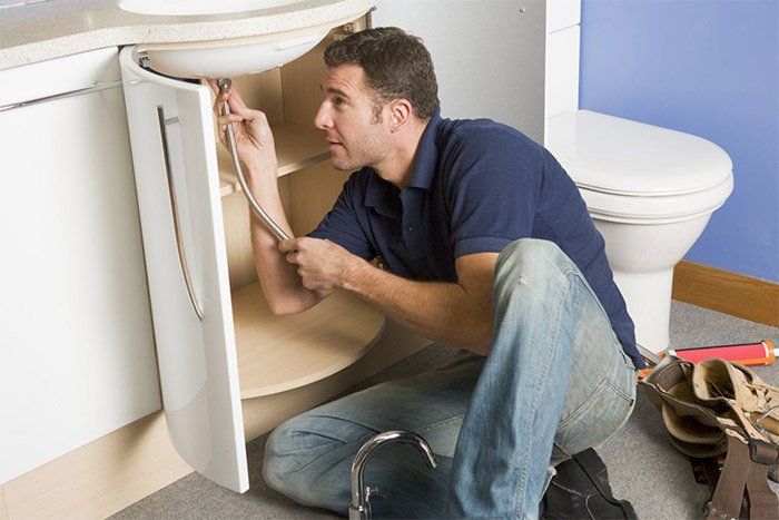 Plumber unblocking sink