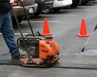 Man Repairing A Parking Lot — Pavement Sealing in El Paso, TX Man Repairing A Parking Lot — Pavement Sealing in El Paso, TX