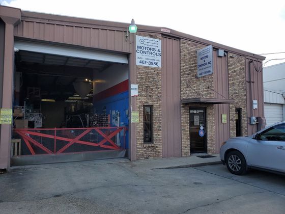 Technician Checking Air Conditioner | Kenner, LA | Motors and Controls, Inc Technician Checking Air Conditioner | Kenner, LA | Motors and Controls, Inc