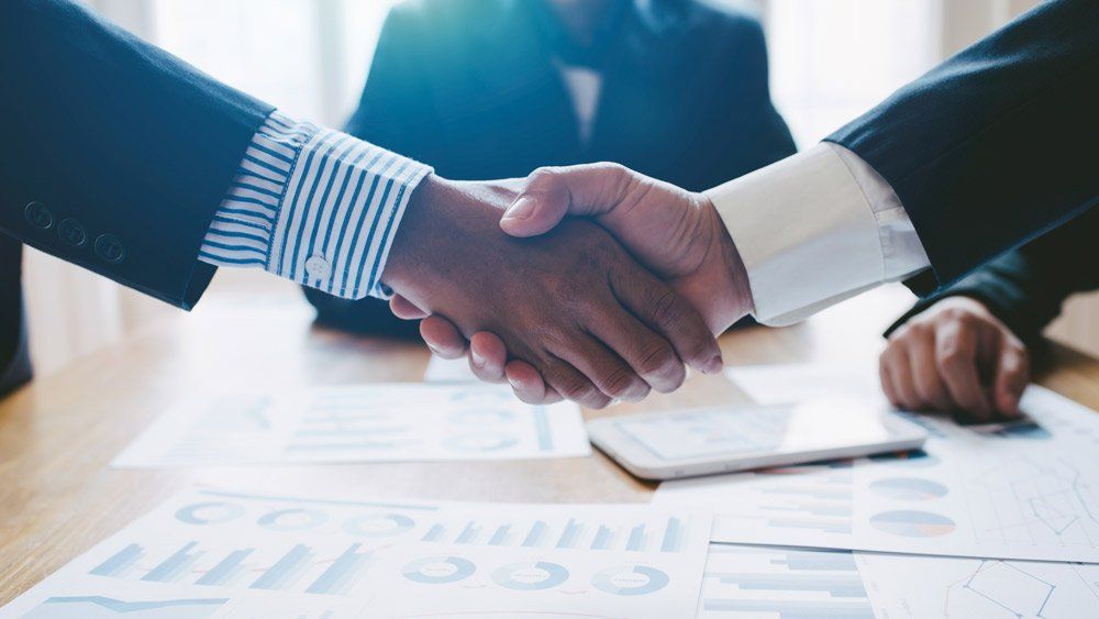 Young Man Business People Shaking Hands — Summerville, SC — Shepherd Law Firm, LLC