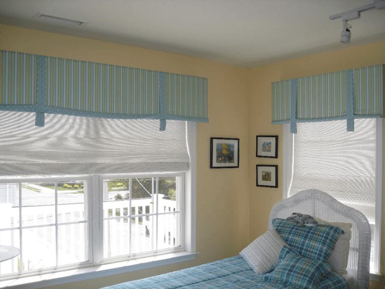 Beautiful soft fabric valance over a woven natural roman shade.