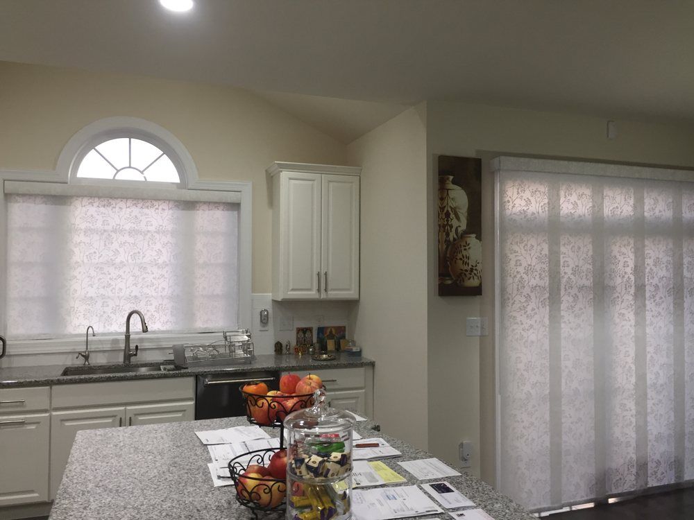 Panel track shade with matching roller shades are great for kitchens!