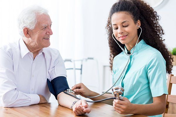 Professional Nurse Checking Patient's Blood Pressure — Savannah, GA — Vickie’s Helping Hands Professional Nurse Checking Patient's Blood Pressure — Savannah, GA — Vickie’s Helping Hands