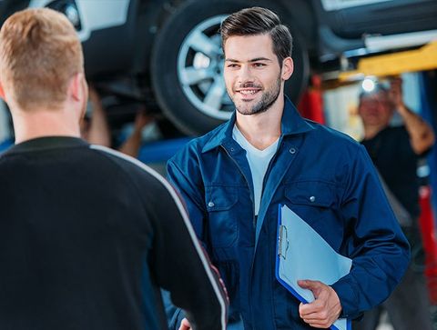 Auto Repair — Mechanic welcoming client in Islip, NY Auto Repair — Mechanic welcoming client in Islip, NY