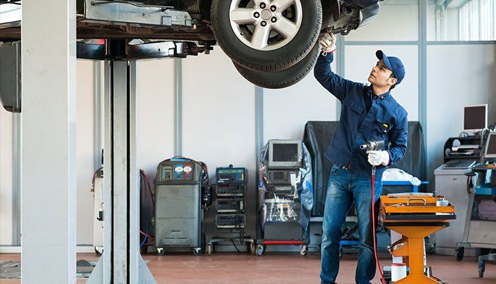 Wheel Alignment — Mechanic at Work in Islip, NY