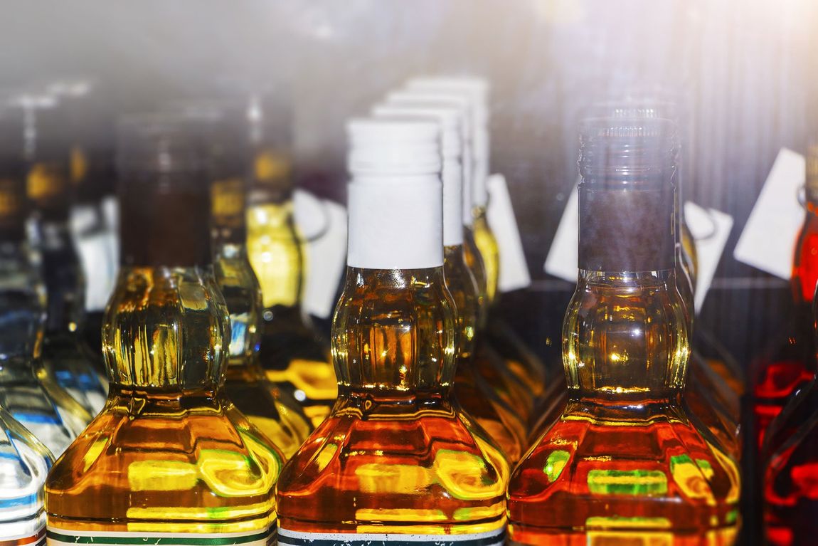 Close-up of a bottle of whiskey, a bottle of alcohol of dark color