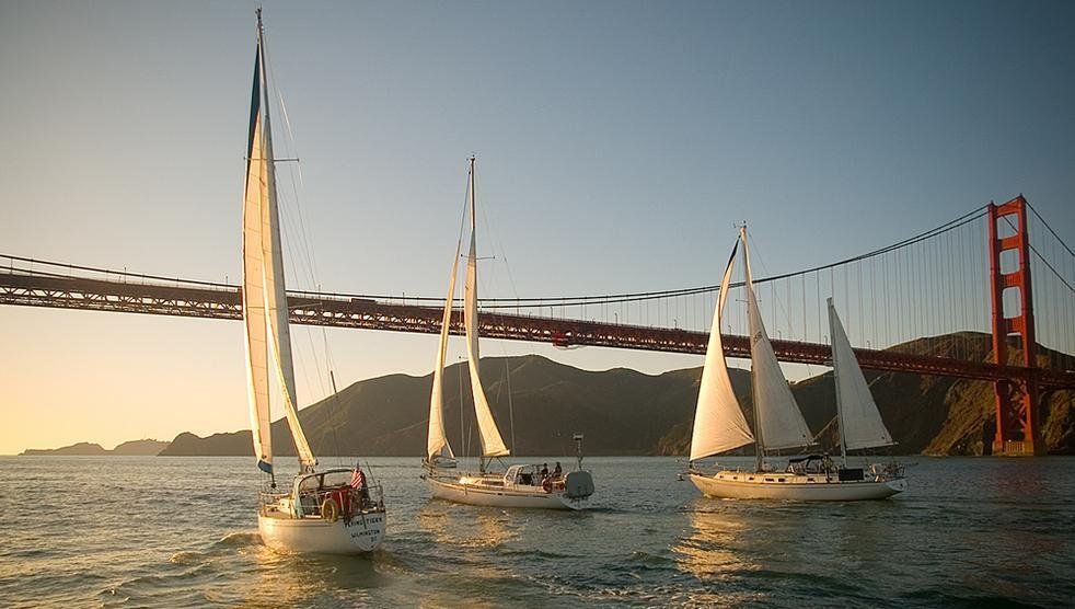 Bay Wolf, Mahalo, and Osprey sailing under the Golden Gate Bridge for sunset. 