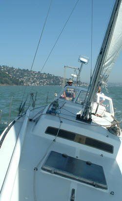 Sailing on a windy day with the Sausalito waterfront in the background. 