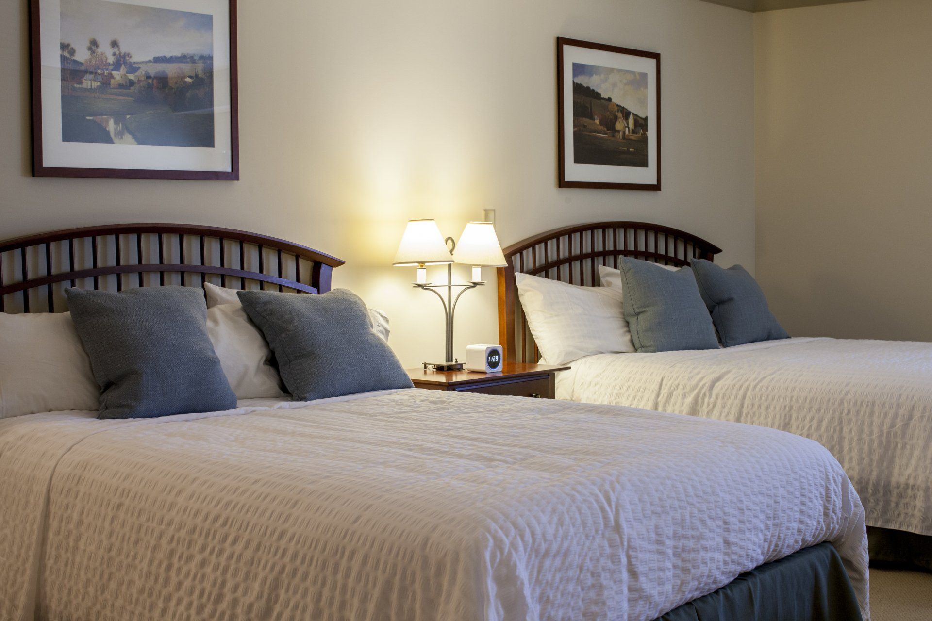 Two queen size beds with a night stand