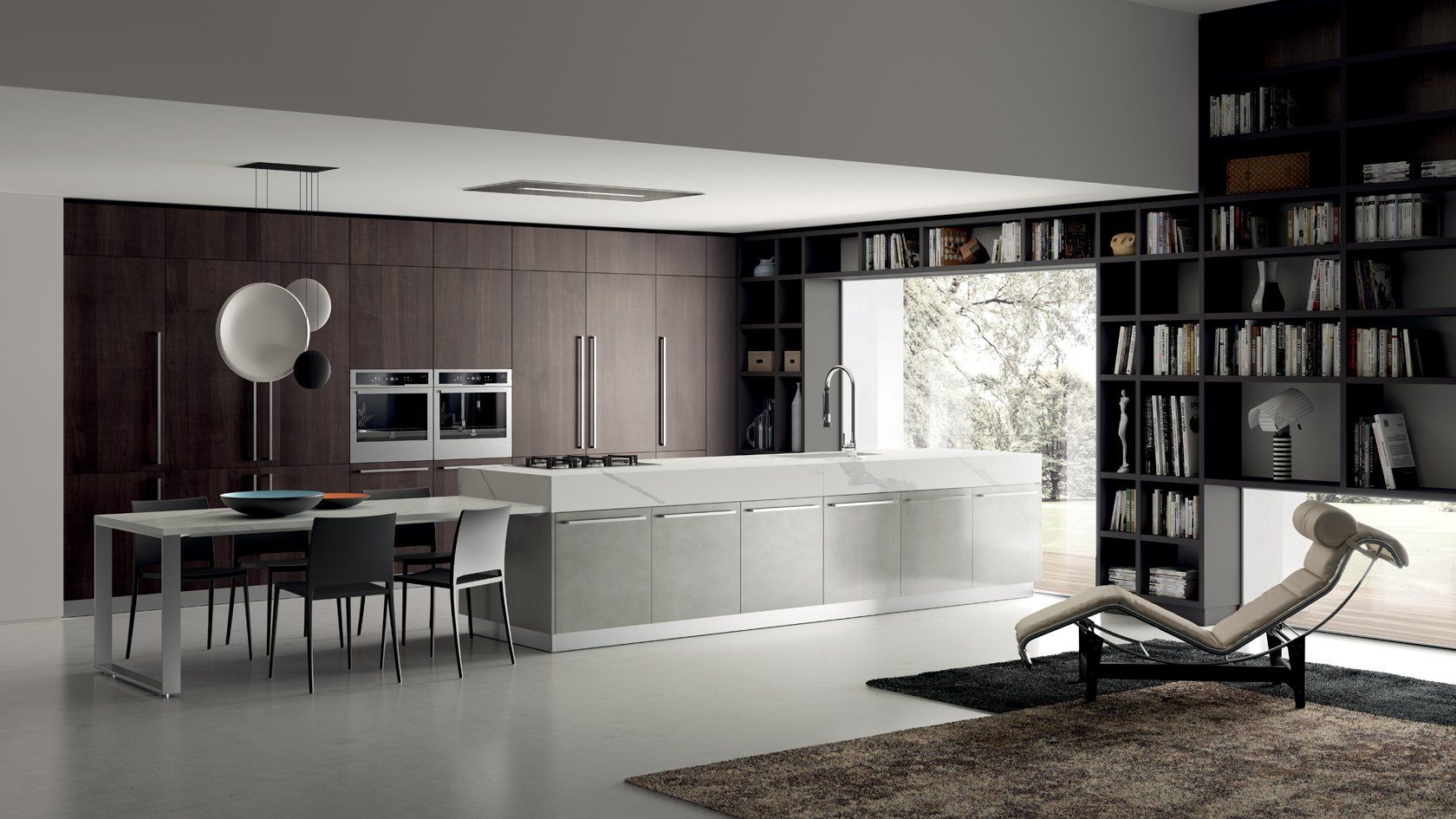 Cucina moderna con mobili in legno scuro, isola in marmo e libreria.