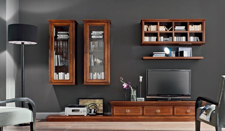 Centro multimediale in legno con TV, librerie e mobili su una parete grigio scuro.
