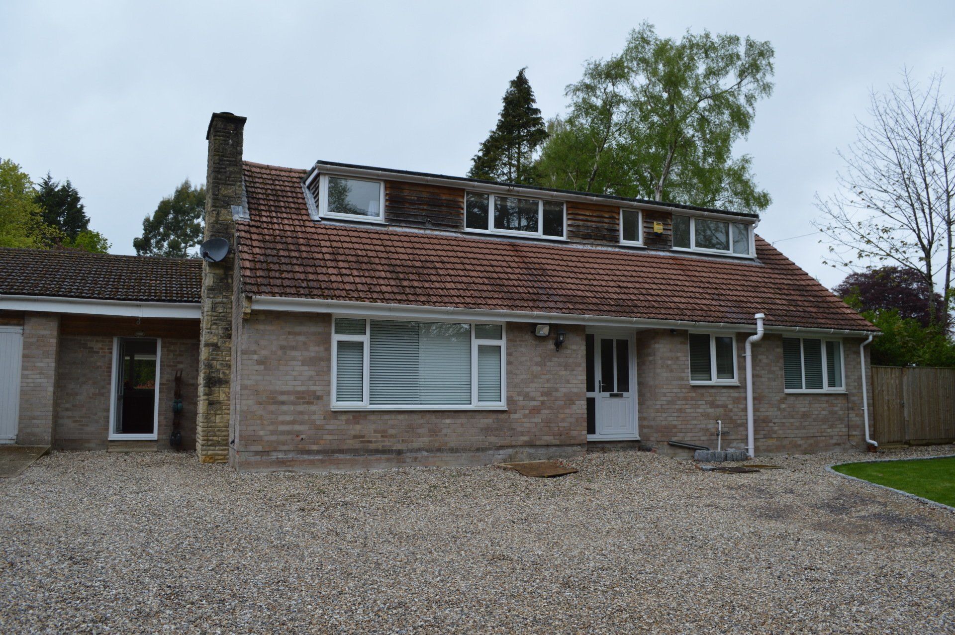 Before: The house is a dated bungalow