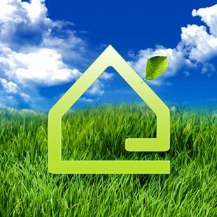 A green house with a leaf on top of it in a field of grass