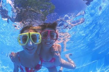 Hot Tubs — Girls Smiling While Swimming in Lindstrom, MN Hot Tubs — Girls Smiling While Swimming in Lindstrom, MN