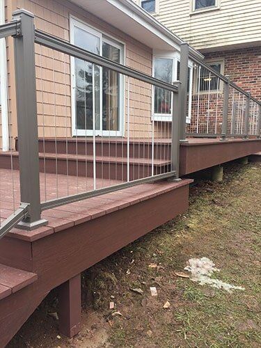 This Is An Azek Deck With Plugs Covering All Screws For A Smooth Deck Surface And A Aluminum Key Link — Decking Services in Wyncote, PA