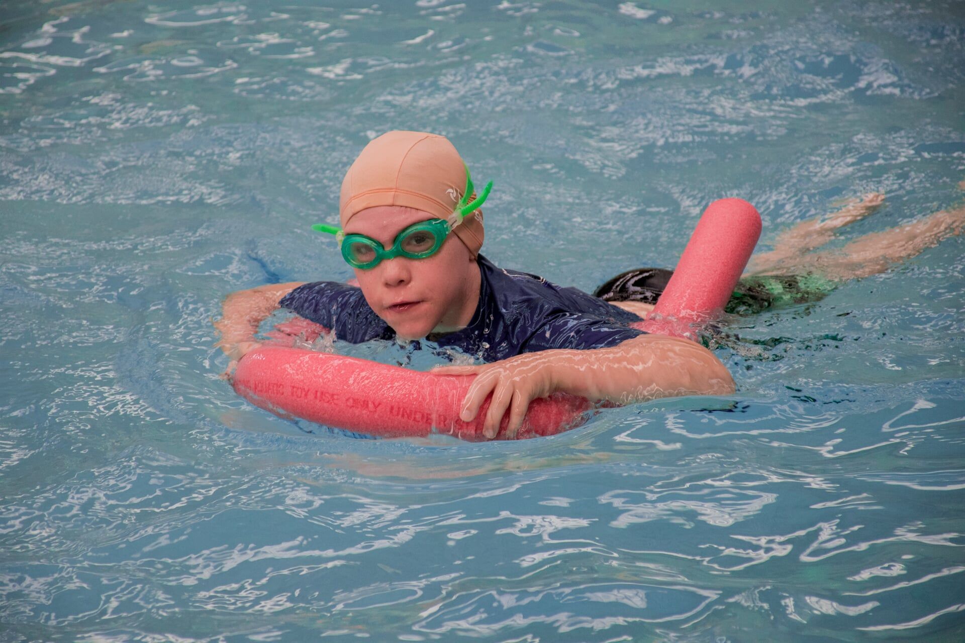 Kid on a Pool Noodle — Swim School in Barney Point, QLD Kid on a Pool Noodle — Swim School in Barney Point, QLD
