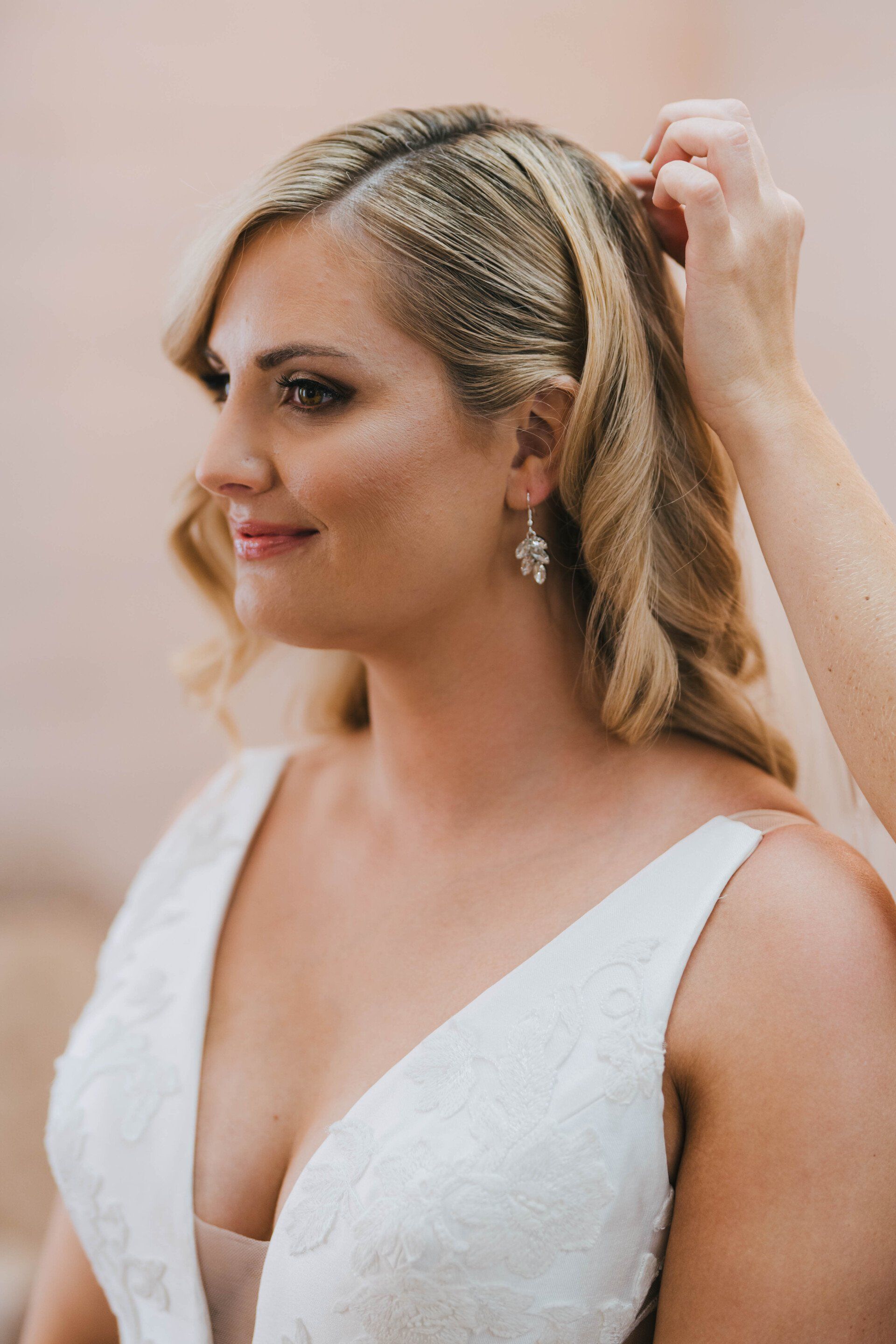 Bride putting on her veil