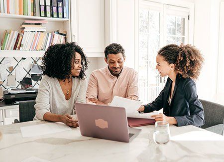 Couple speaking to their accountant.