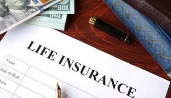 Insurance Agency — Life Insurance Policy and Currency on Table in Orlando, FL Insurance Agency — Life Insurance Policy and Currency on Table in Orlando, FL