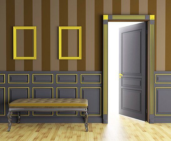 A room with a bench and a door that is open