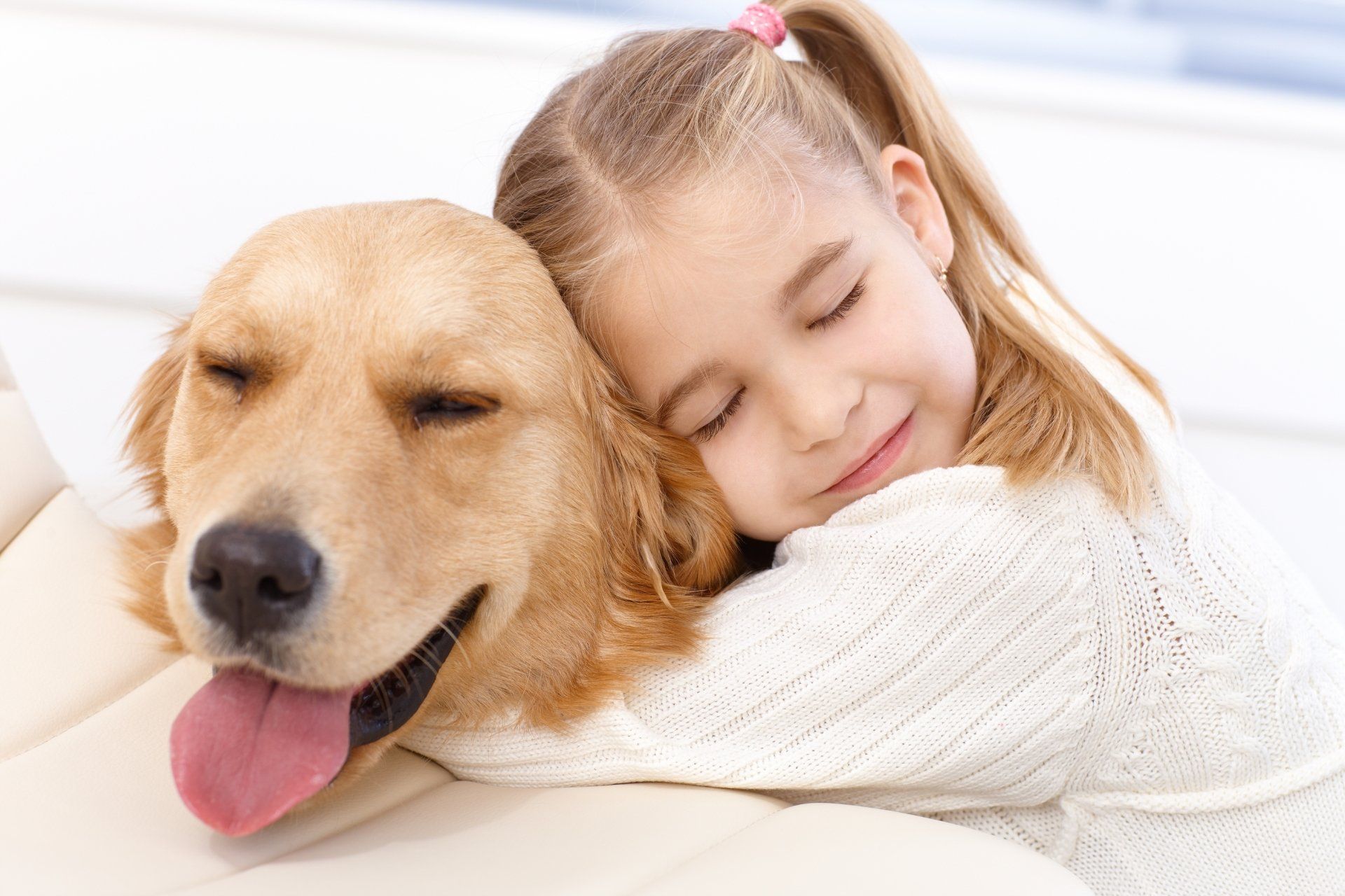 Girl cuddles dog Young Girl cuddles her beloved dog