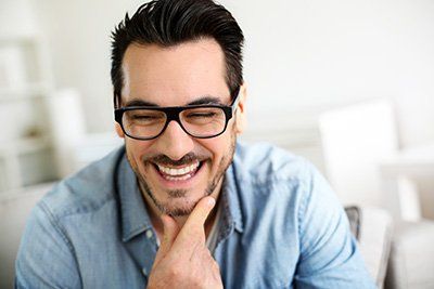 Smiling Man Wearing an Eyeglass - Hartzell Rupp Ophthalmology in Mechanicsburg, PA Smiling Man Wearing an Eyeglass - Hartzell Rupp Ophthalmology in Mechanicsburg, PA