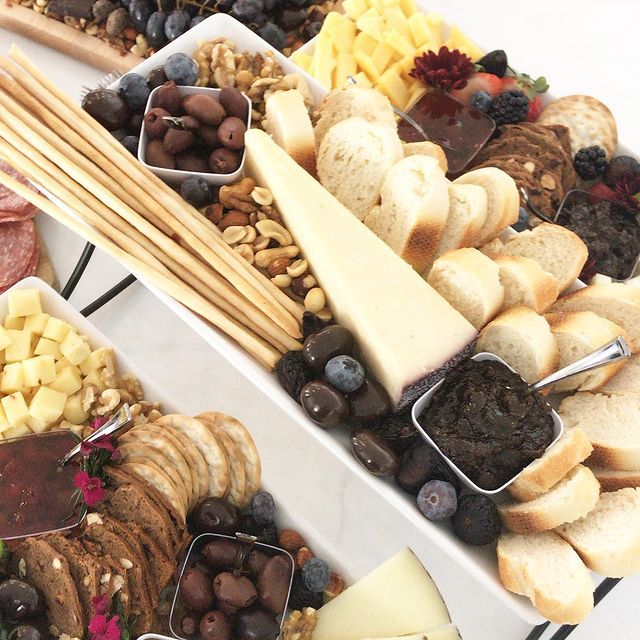 A variety of food including cheese bread and nuts on a table