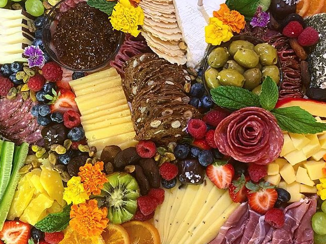 There are many different types of fruits and vegetables on the table.