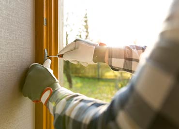 Garage Door — Hand Fixing a Garage Door in Lomita, CA