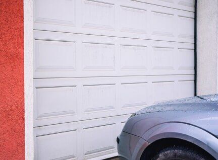 Residential Garage Door — Garage Door and Car in Lomita, Garage Door Repair — Man Fixing Garage Door in Lomita, CA Residential Garage Door — Garage Door and Car in Lomita, Garage Door Repair — Man Fixing Garage Door in Lomita, CA
