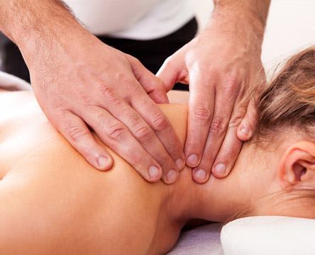 Neck and shoulder's massage A therapist's hands are massaging a lady's neck