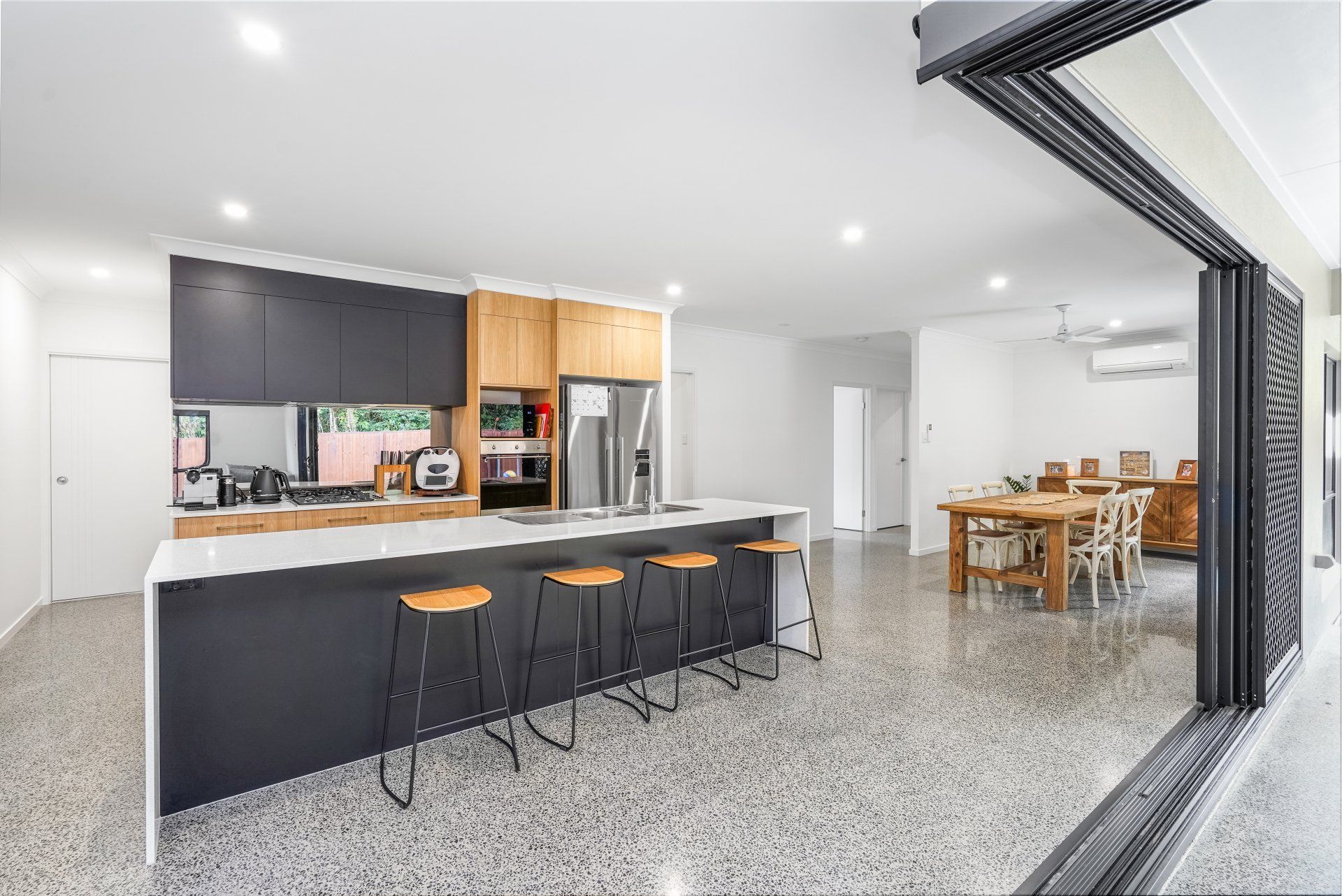 Spacious Kitchen With White And Dark Gray Countertop — Kitchen Design in Edmonton, QLD