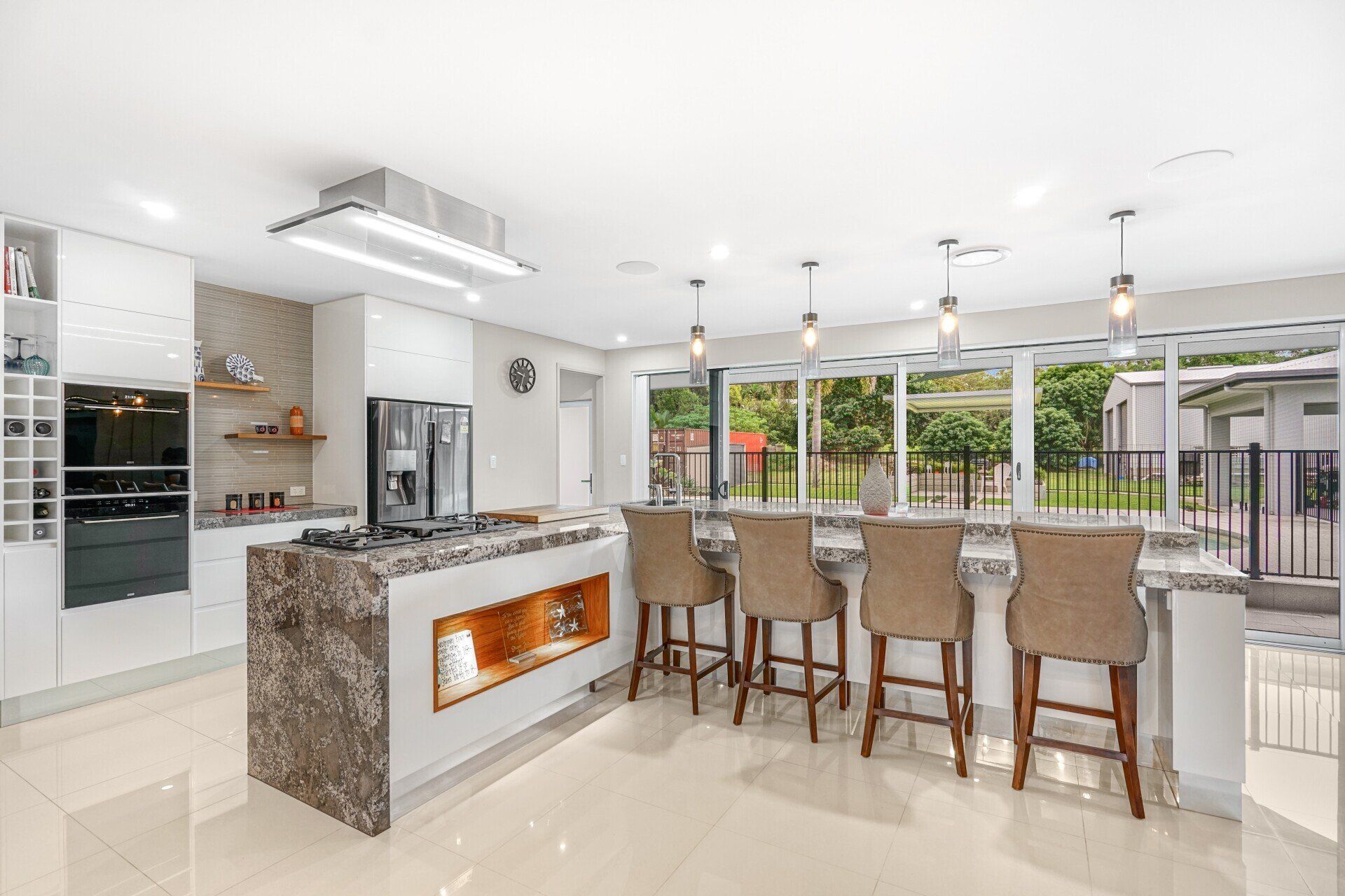 Kitchen With Brown Glossy Countertop — Kitchen Design in Edmonton, QLD