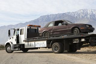 Emergency Towing — Broken Car on Tow Truck in Greenville, NC Emergency Towing — Broken Car on Tow Truck in Greenville, NC