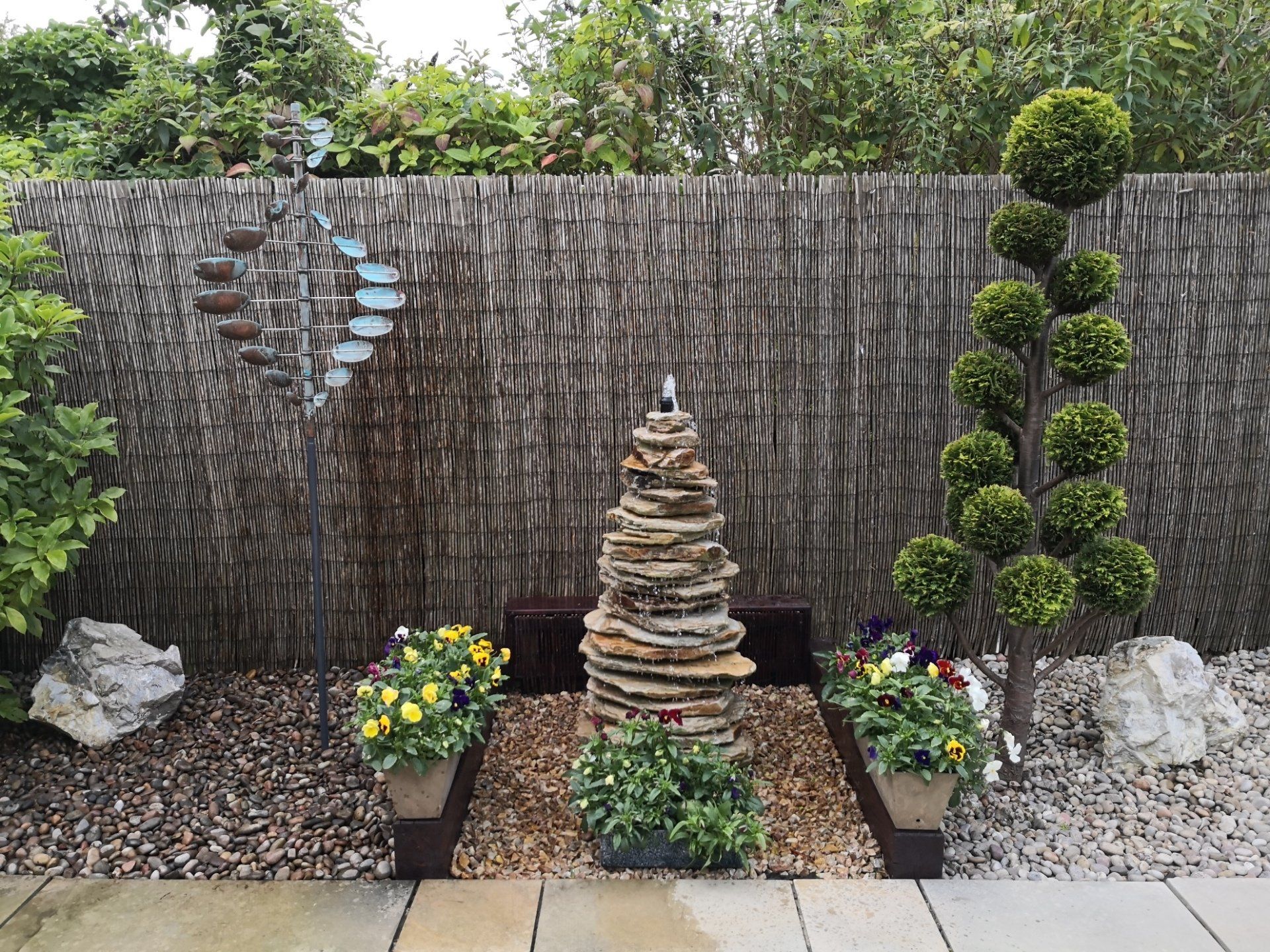 There is a fountain in the middle of the garden.